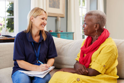 caregiver and a senior woman having a conversation